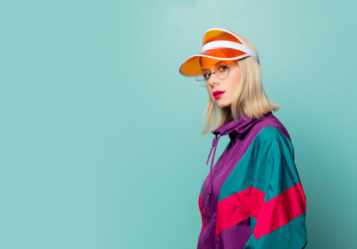 Style blonde woman in 80s glasses and hat