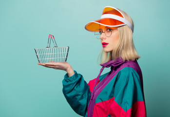 Style blonde woman in 90s sport suit with shopping basket