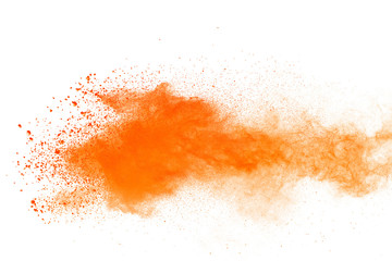 Abstract orange powder explosion. Closeup of orange dust particle splash isolated on white background.