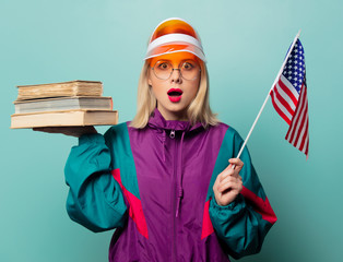 Style blonde woman in 90s sport suit with books and USA flag
