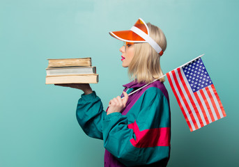 Style blonde woman in 90s sport suit with books and USA flag