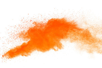 Abstract orange powder explosion. Closeup of orange dust particle splash isolated on white background.