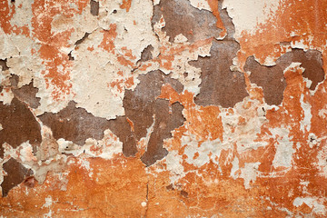 Concrete painted wall with falling cracked paint.