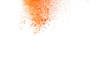 Abstract orange powder explosion. Closeup of orange dust particle splash isolated on white background.
