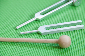 healing tuning fork and crystal stone on table .