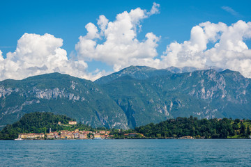 Scenic view of Lake Como on a sunny summer day. The village of Bellagio, located on the shores of Lake Como and the high mountain behind it, Lombardy, Italy.