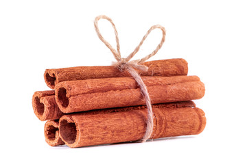 Cinnamon sticks tied with natural jute rope. Cinnamon stack isolated on white background.