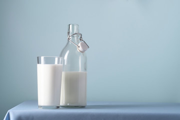 Glass of milk, bottle on a blue background
