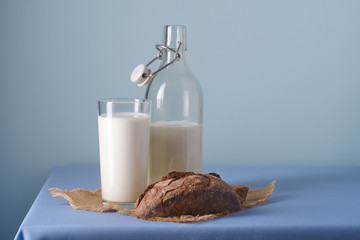Glass of milk, slices of bread, on a blue background