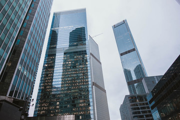 Fototapeta na wymiar Modern skyscrapers close-up toned in blue color.