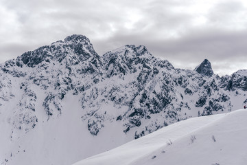 Winter in the mountains and the snowy valleys of the Alps during a fantastic winter day, near the town of Schilpario, Italy - January 2020.