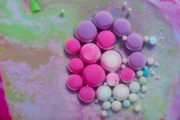Ink Bubbles In Water. Colorful ink reacting in water creating abstract background.