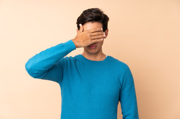 Man over isolated background covering eyes by hands. Do not want to see something