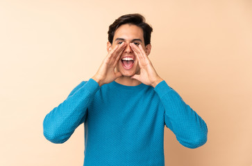 Man over isolated background shouting and announcing something