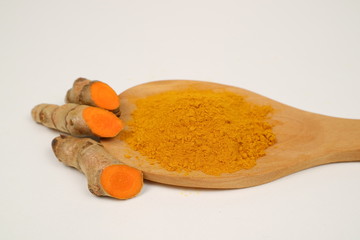 Turmeric powder (turmeric) and turmeric roots isolated on a white background are used as...