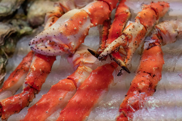 Crab legs fresh sea food on ice background