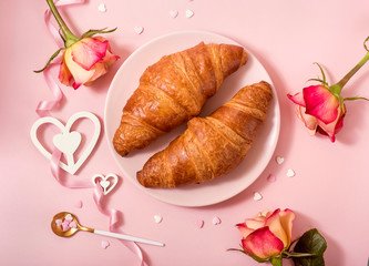 Romantic breakfast with croissants, roses on pink background, Valentine's day celebration, love concept - 320087413