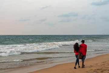 Young people couple walking along Indian ocean, Colombo, Sri Lanka