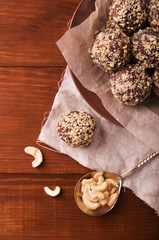 Obraz na płótnie Canvas Cocoa balls, chocolate truffles cakes on board on wooden background