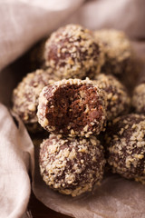 Cocoa balls, chocolate truffles cakes on board on wooden background