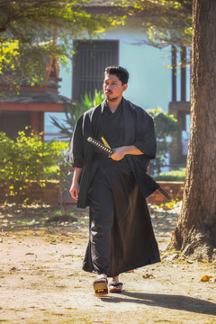 Samurai warriors are walking around the temple in the afternoon.
