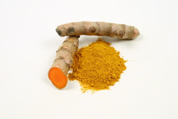 Turmeric powder and turmeric root extract on a white background, used as a tonic for body and food ingredients.