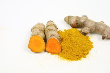 Turmeric powder and turmeric root extract on a white background, used as a tonic for body and food...