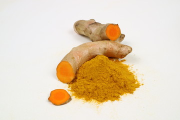 Turmeric powder and turmeric root extract on a white background, used as a tonic for body and food...