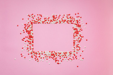 Fototapeta na wymiar Colorful Valentines Day hearts on pink background