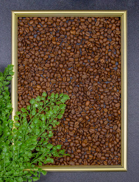 photo frame with coffee beans on a gray background, flat lay, top view, copy space. © DmitrySolmashenko
