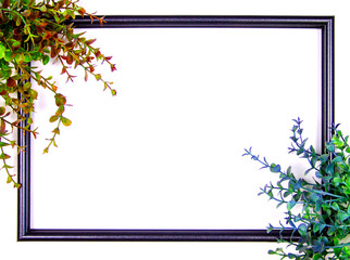 Decorative composition, black photo frame on a white background, branches with leaves. Flat lay, top view, copy space.