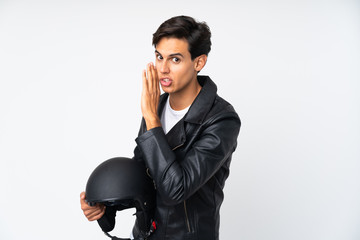 Man holding a motorcycle helmet over isolated white background whispering something