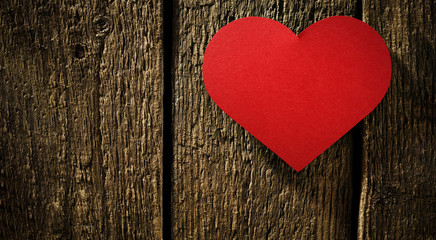 Obraz na płótnie Canvas Valentine's Day background of wooden board and red paper hearts.Copy space for your decoration. 