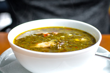chakapuli, meat and greens soup in white plate, georgian traditional food