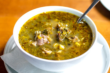 chakapuli, meat and greens soup in white plate, georgian traditional food