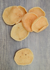 prawn cracker chips isolated on wooden background