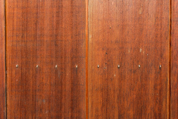 Obraz premium Nice and clean brown wood wall in vertical line seamless pattern. Wooden grain texture and surface. Ideal for background or wallpaper with copy space. 