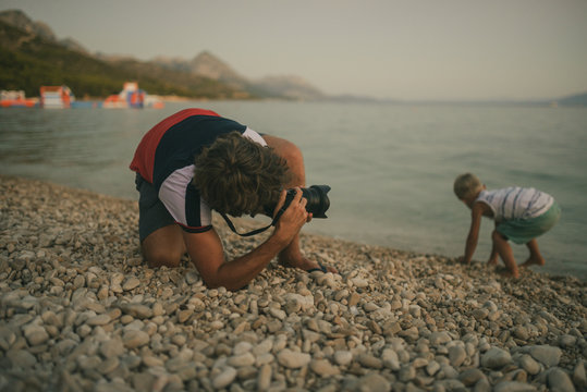 Father taking photo of his son