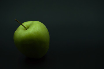 green apple on black background