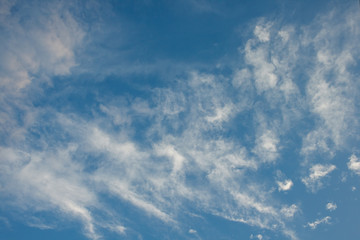 Fototapeta premium Scattered white clouds on blue sky.