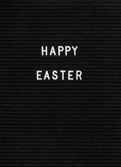 The words Happy Easter on black felt letter board