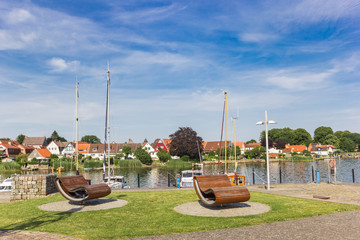 Benches and boats at the harbor of Schleswig, Germany