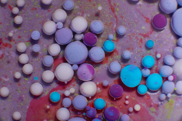 Fototapeta na wymiar Ink Bubbles In Water. Colorful ink reacting in water creating abstract background.