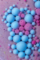 Ink Bubbles In Water. Colorful ink reacting in water creating abstract background.