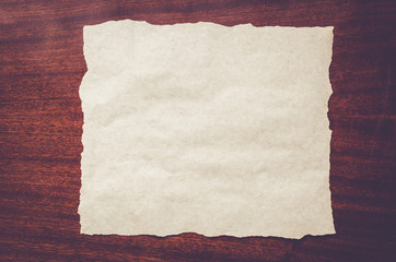white sheet of paper on a wooden background
