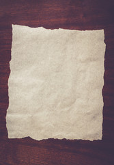 white sheet of paper on a wooden background