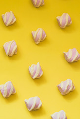 Pink marshmallows on a yellow gradient background