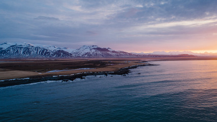 view of a beautiful sunset over the mountains on the shore of the Atlantic Ocean in Iceland