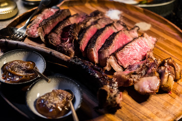 Medium rare Tomahawk meat on wooden plate
