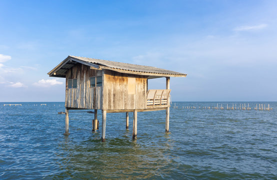 Wooden timber houses on stilts in water sea with clear blue sky near coast,home of fishing village for fisherman